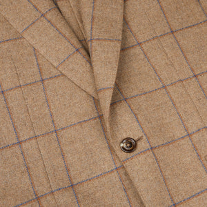 A close up of a Caramel Estate Wool Tweed Provence jacket with blue buttons, designed by Alexander Kraft Monte Carlo.