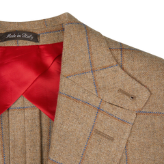 Alexander Kraft Monte Carlo's Caramel Estate Wool Tweed Provence Jacket, crafted from pure wool, is perfectly complemented with a vibrant red tie.