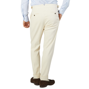 The back view of a man wearing Alexander Kraft Monte Carlo's Cream White Cotton Twill Updated Gurkha Trousers.