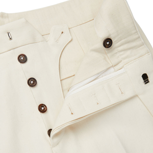 A close up of a slim-cut, Cream White Cotton Twill Updated Gurkha Trousers by Alexander Kraft Monte Carlo.