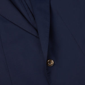 A close-up of a Navy Blue Loro Piana Wool Unstructured PPJ Jacket with buttons, also known as the Alexander Kraft Monte Carlo Private Plane Jacket.