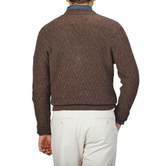 A person wearing an Altea Brown Wool Chevron Knit V-Neck and white pants is shown from the back against a plain background.