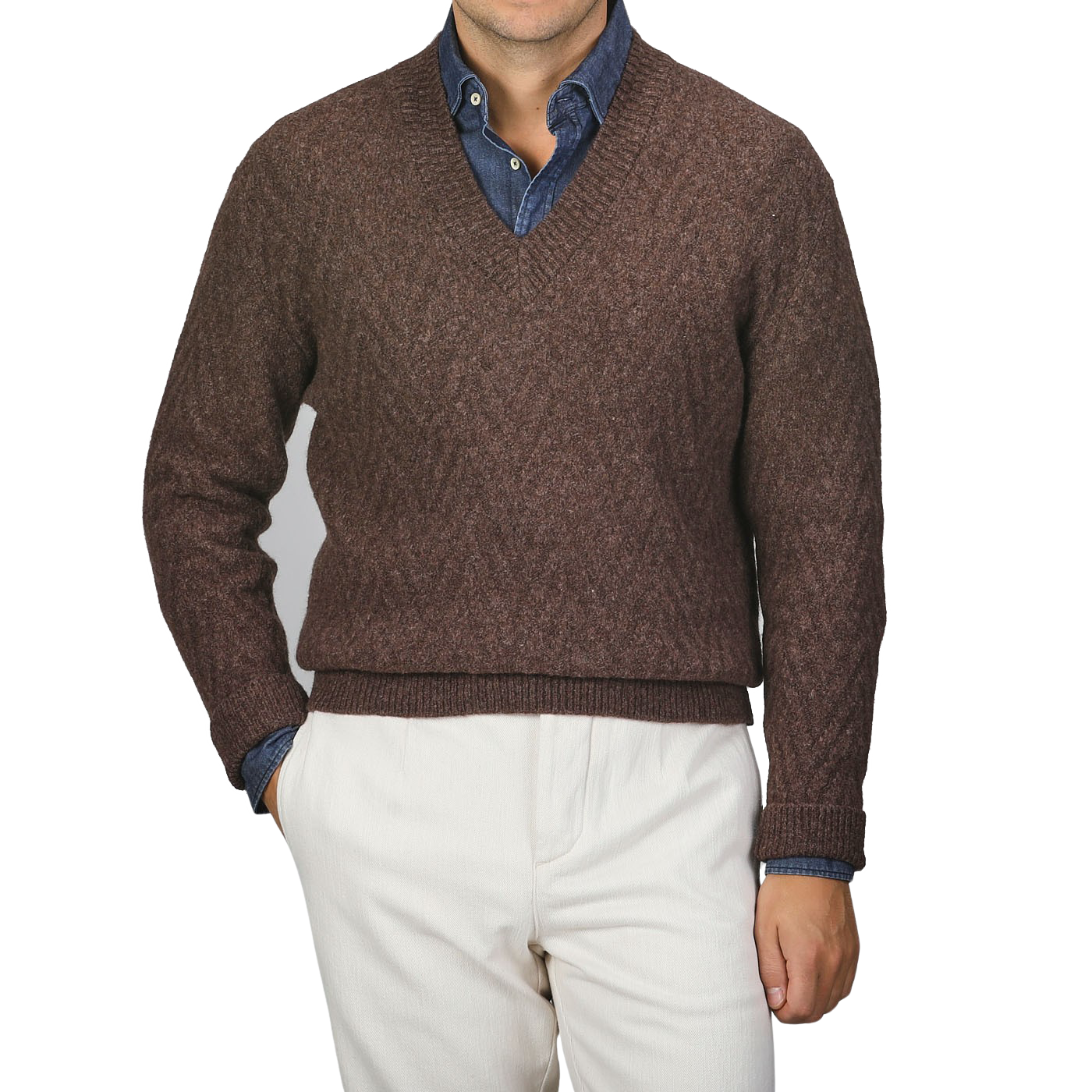 A person wearing an Altea Brown Wool Chevron Knit V-Neck over a blue denim shirt, paired with light beige pants.