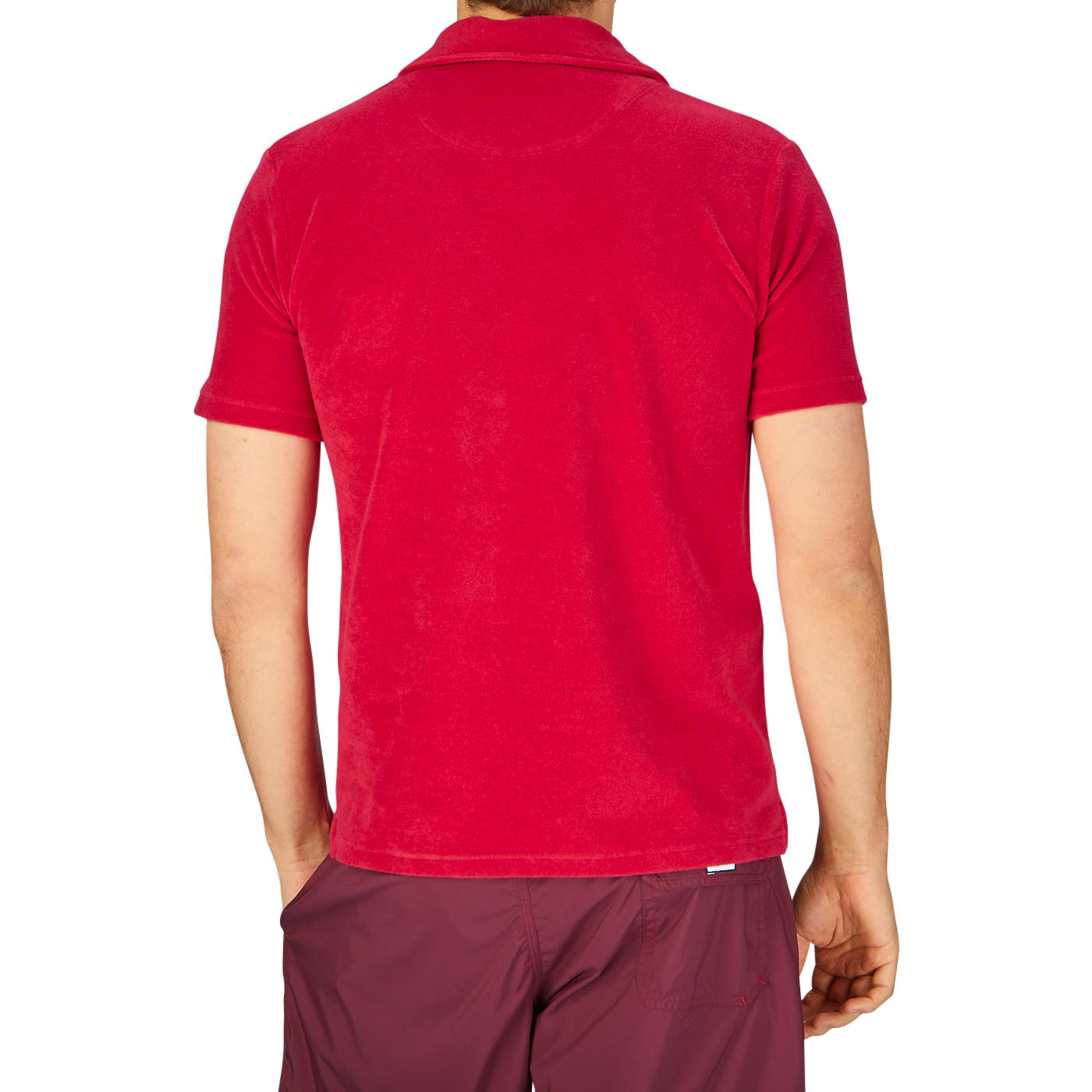 Rear view of a person wearing an Altea Coral Red Cotton Towelling Capri Collar Polo Shirt and maroon shorts against a grey background.