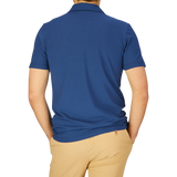 A man seen from the back wearing an Altea dark blue cotton jersey capri collar polo shirt and beige pants.
