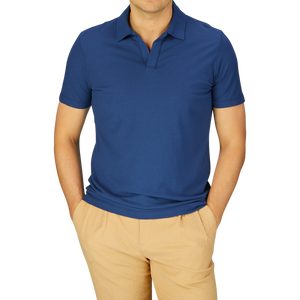Man wearing a slim fit Altea dark blue cotton jersey Capri collar polo shirt and beige trousers.
