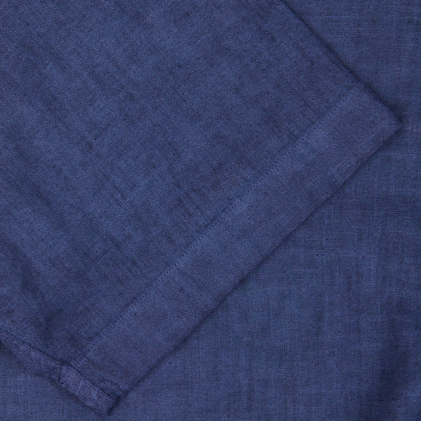 Close-up of a Altea dark blue linen blend open collar shirt fabric texture with visible woven details, a summer essential.