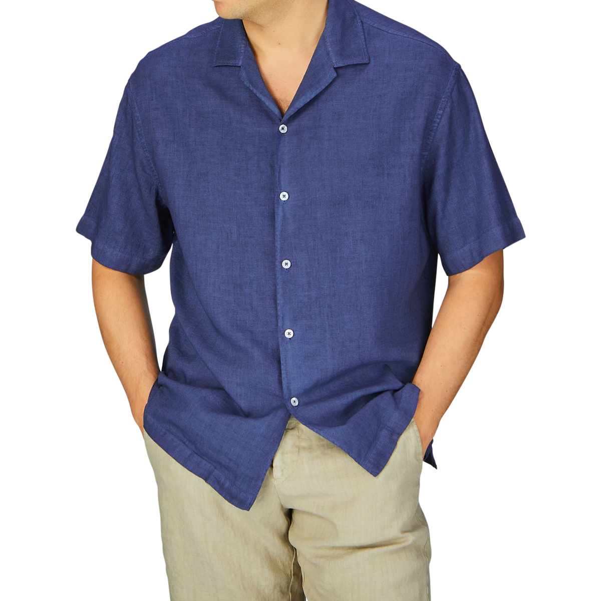 Man in a Dark Blue Linen Blend Open Collar Shirt and beige pants with hands in pockets, embodying a summer essential look by Altea.