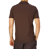 Rear view of a person wearing a Altea Dark Brown Cotton Jersey Capri Collar Polo Shirt and dark pants.