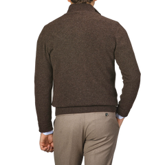 Man standing with his back to the camera, wearing an Altea Dark Brown Shetland Wool Button Cardigan and light brown pants.