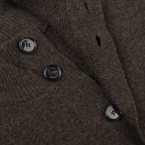 Close-up of the Altea Dark Brown Shetland Wool Button Cardigan featuring three black buttons with text on them. The cardigan fabric appears textured.