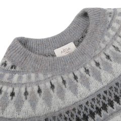 Close-up of a grey melange Norwegian wool-alpaca blend crewneck with a geometric pattern and a tag reading "Altea Milano".