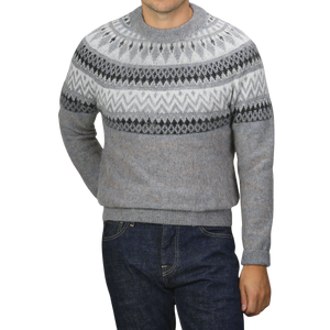 A person wearing the Altea Grey Melange Norwegian Wool Alpaca Crewneck sweater and dark blue jeans stands against a plain background, with their face not visible.