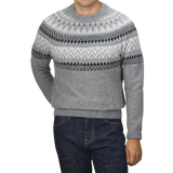 A person wearing the Altea Grey Melange Norwegian Wool Alpaca Crewneck sweater and dark blue jeans stands against a plain background, with their face not visible.