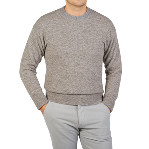 A man wearing an Altea Grey Melange Wool Alpaca Crewneck Sweater.