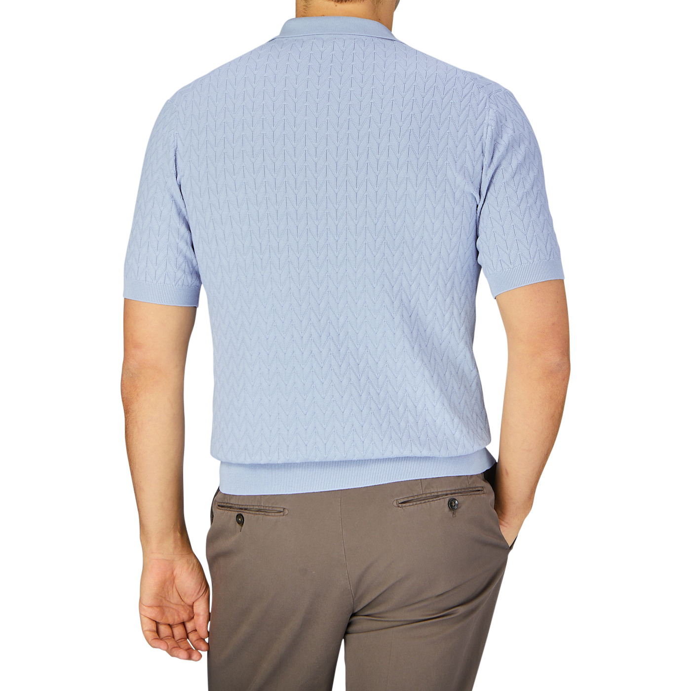 A man standing with his back to the camera, wearing a Altea Light Blue Cotton Capri Collar Polo shirt and beige trousers.