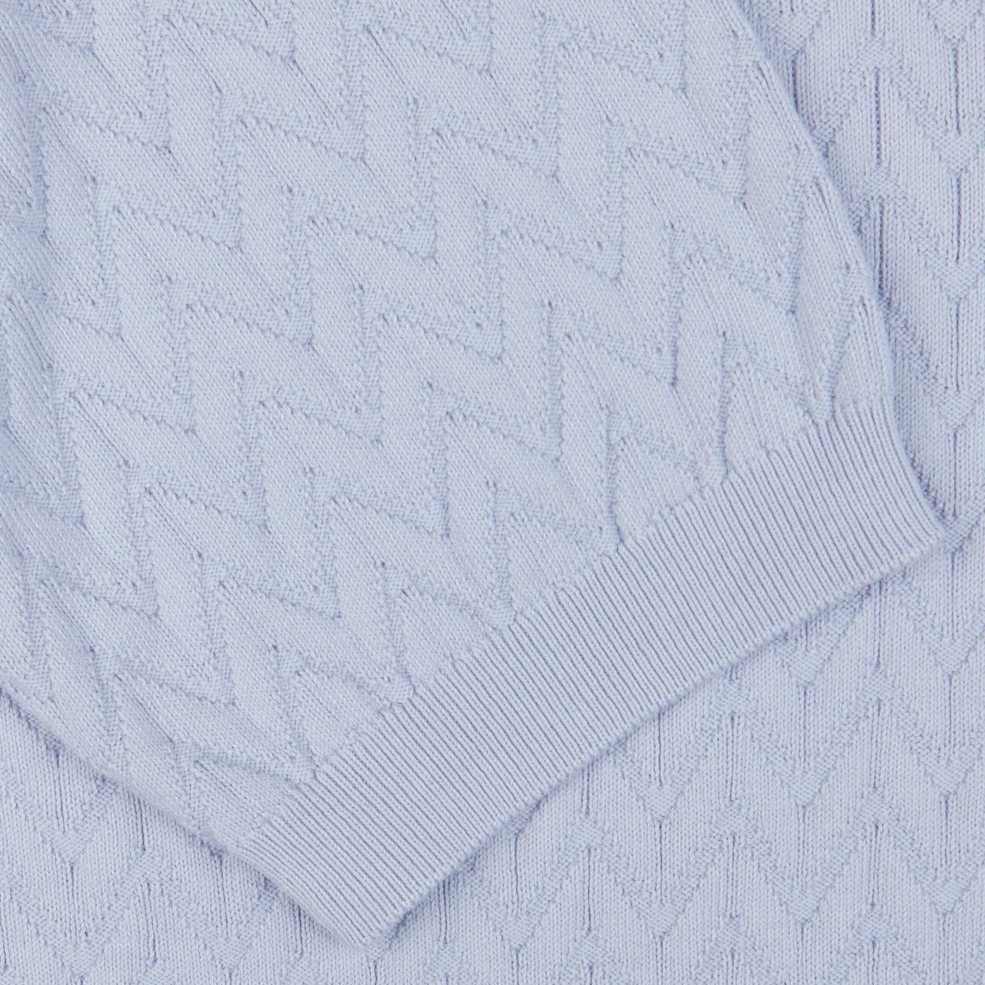 Close-up of a textured Light Blue Cotton Capri Collar Polo Shirt with a knit diamond pattern and ribbed hem, made in Italy by Altea.