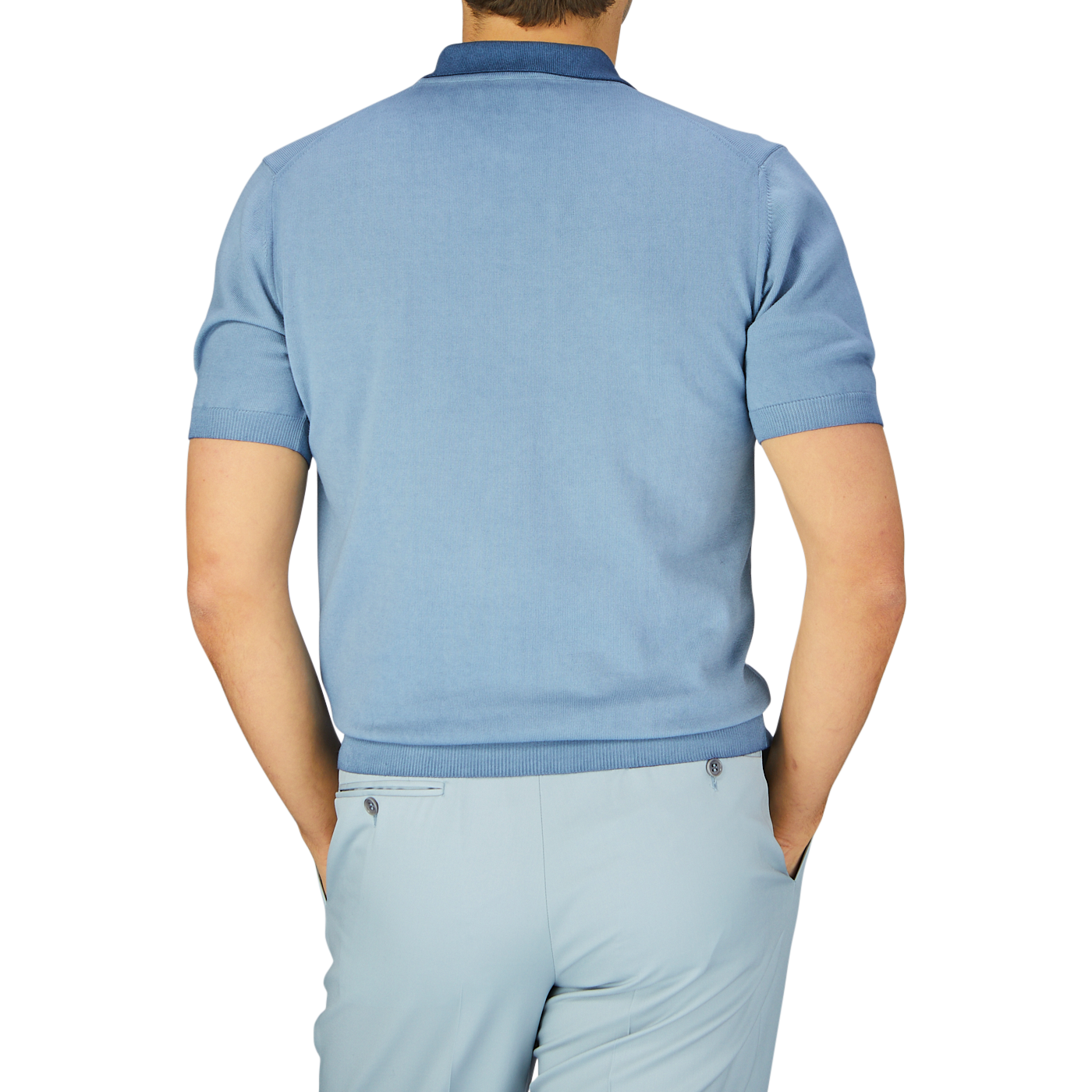 A man seen from behind, wearing a Altea Light Blue Dyed Cotton Capri Collar Polo Shirt and matching trousers against a grey background.