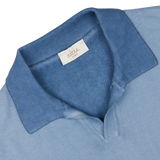 Close-up view of a Light Blue Dyed Cotton Capri Collar Polo Shirt, garment-dyed, with a tag showing the brand name "Altea," made in Italy.