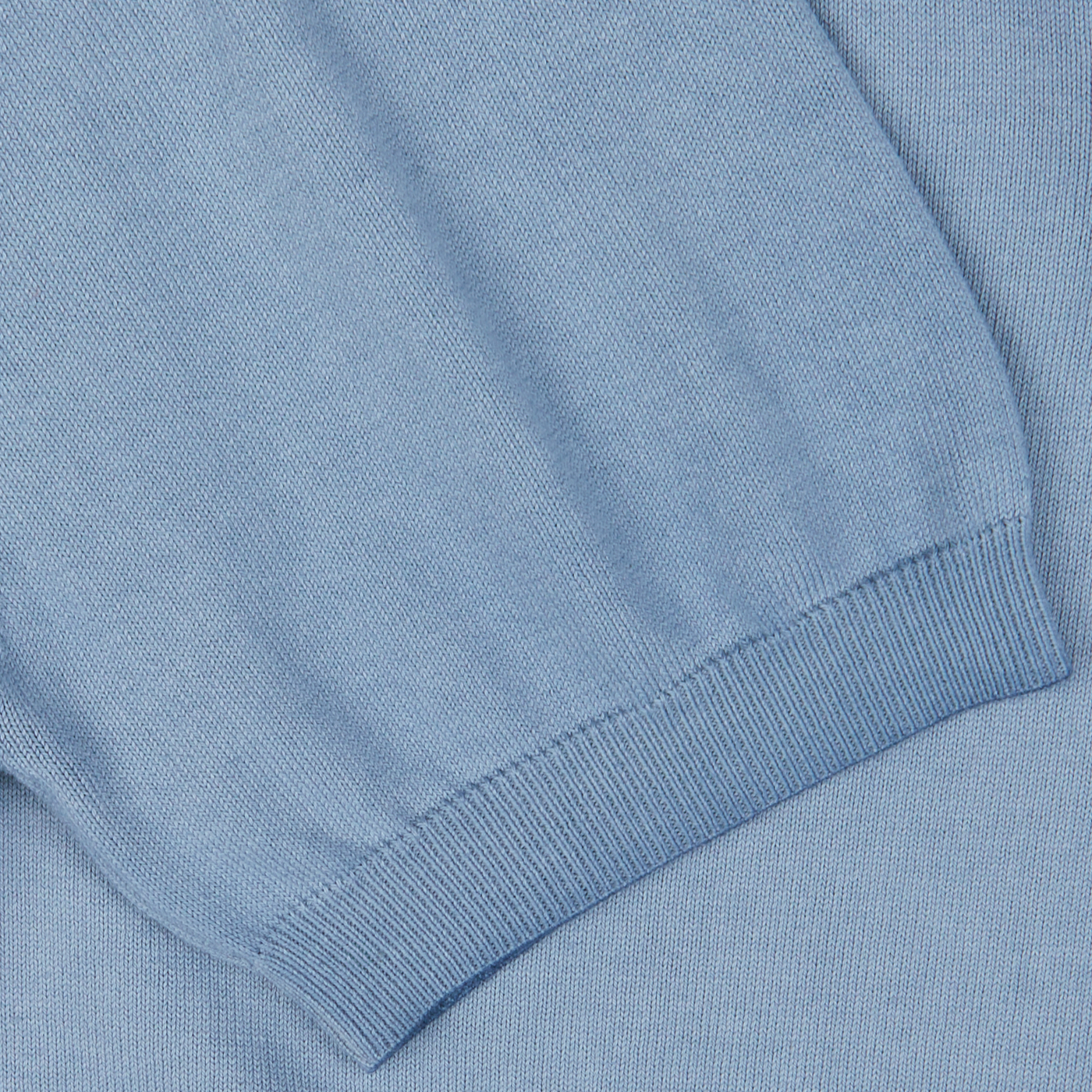 Close-up of a Light Blue Dyed Cotton Capri Collar Polo Shirt by Altea with ribbed hem detailing.