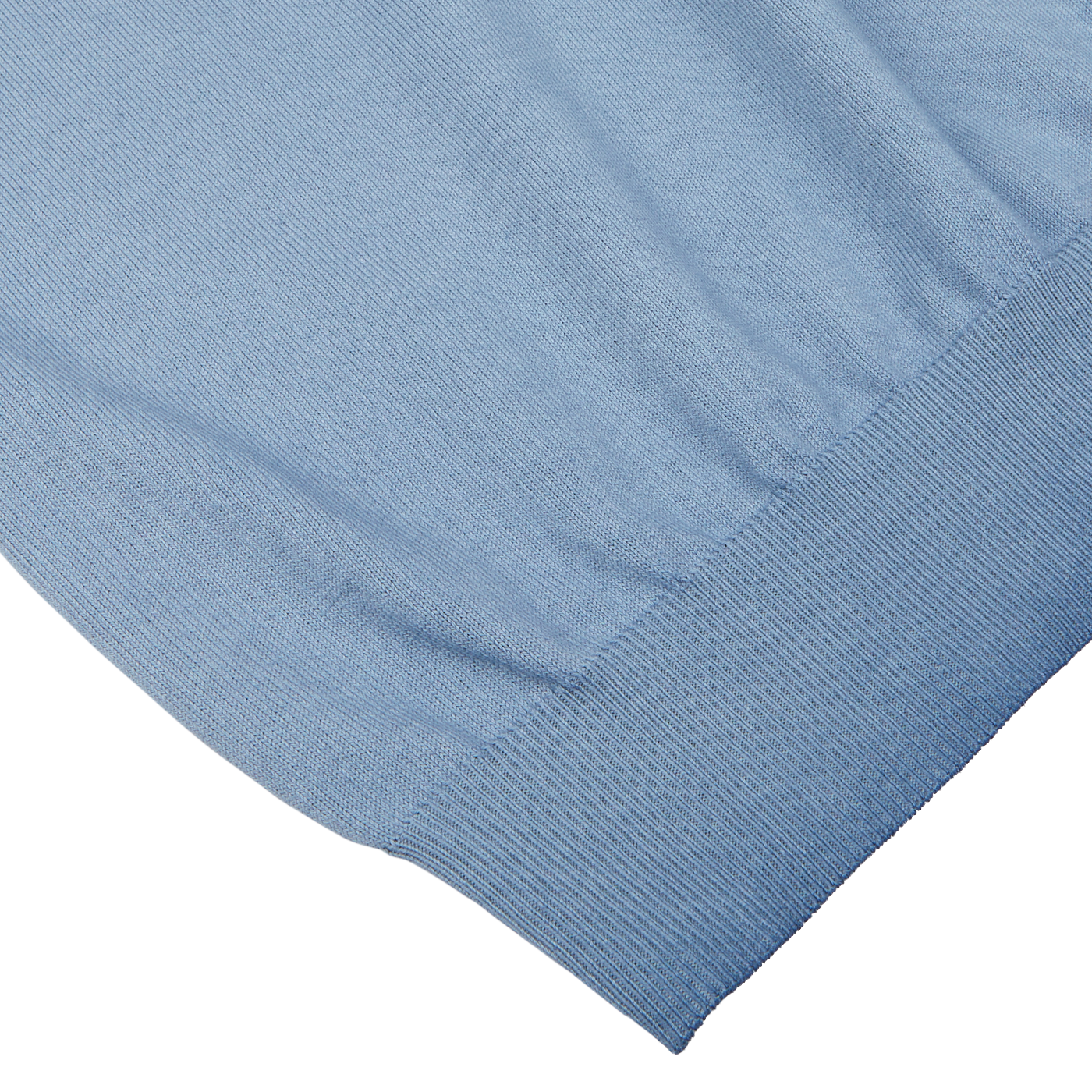 Close-up of a Light Blue Dyed Cotton Capri Collar Polo Shirt with ribbed hemming on a white surface by Altea.