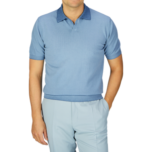 Man wearing a seasonal Light Blue Dyed Cotton Capri Collar Polo Shirt and matching trousers against a plain background, with the garment-dyed shirt made in Italy by Altea.