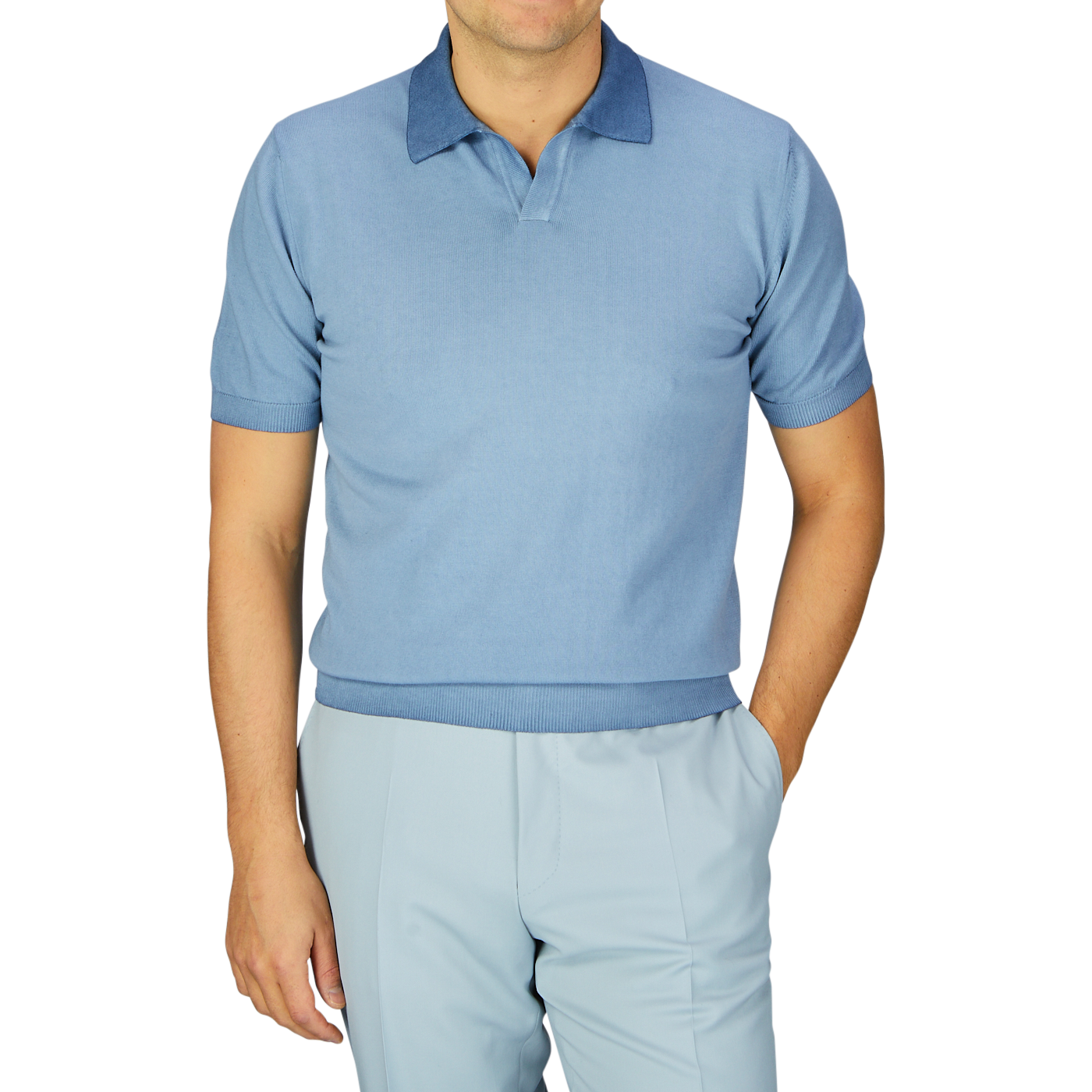 Man wearing a seasonal Light Blue Dyed Cotton Capri Collar Polo Shirt and matching trousers against a plain background, with the garment-dyed shirt made in Italy by Altea.
