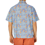 A person viewed from behind wearing an Altea light blue floral printed cotton shirt and orange shorts.