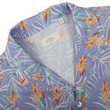 Close-up of a Light Blue Floral Printed Cotton Altea shirt with a visible brand label at the collar, a summer essential.