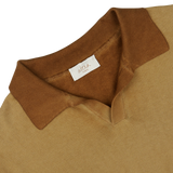 Close-up of a light brown, Altea garment-dyed sweater collar with a white label.