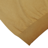 Close-up of Altea's light brown dyed cotton Capri collar polo shirt with a fine texture and neatly hemmed edge on a white background.