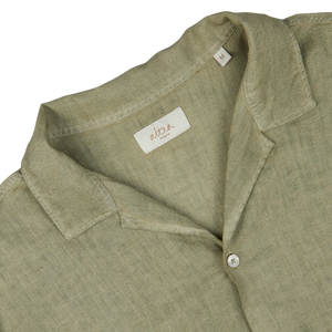 Close-up of an Altea Moss Green Linen Blend Camp Collar Shirt's collar and label.