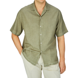 Man wearing a casual Altea Moss Green Linen Blend Camp Collar Shirt and light trousers, ideal as a summer essential.