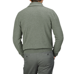 Person wearing an Altea Moss Green Wool Fleece 1/4 Zip Sweater and gray pants, facing away.