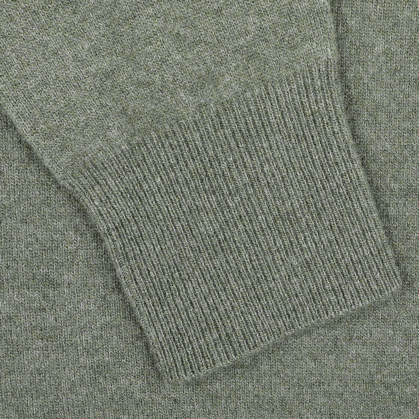 Close-up of the sleeve on Altea's Moss Green Wool Fleece 1/4 Zip Sweater, featuring ribbed cuff detailing and made from a cozy wool blend.