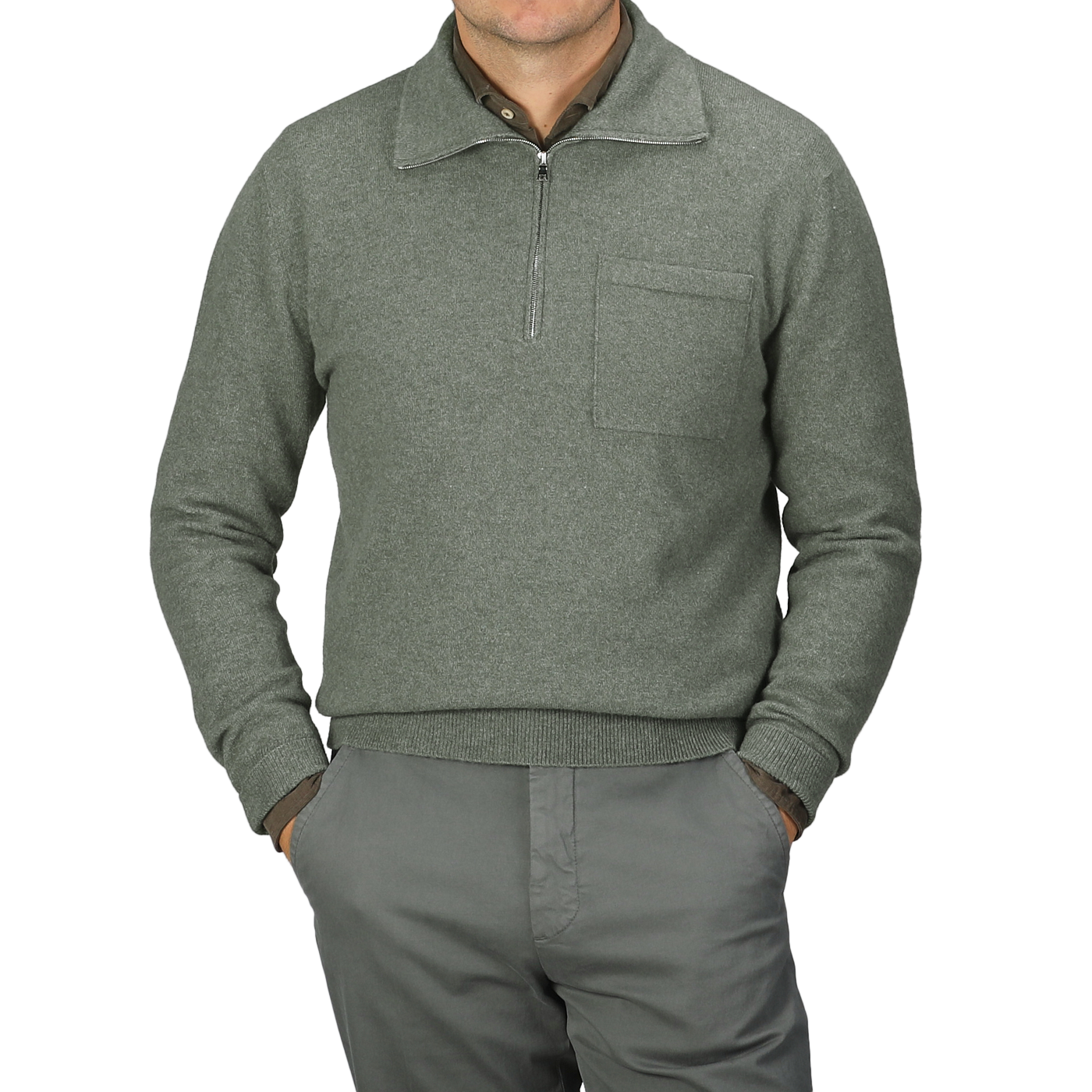 An individual dressed in the Altea Moss Green Wool Fleece 1/4 Zip Sweater and matching pants stands with their hands in pockets.