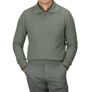 An individual dressed in the Altea Moss Green Wool Fleece 1/4 Zip Sweater and matching pants stands with their hands in pockets.