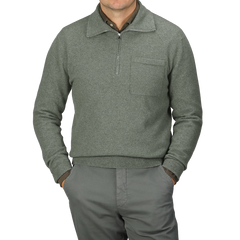 An individual dressed in the Altea Moss Green Wool Fleece 1/4 Zip Sweater and matching pants stands with their hands in pockets.