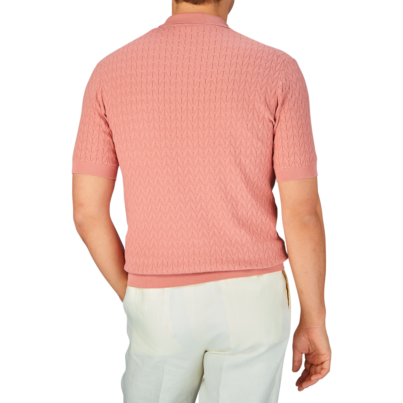 A man standing with his back to the camera wearing a Muted Pink Cotton Capri Collar Polo Shirt by Altea and white pants.