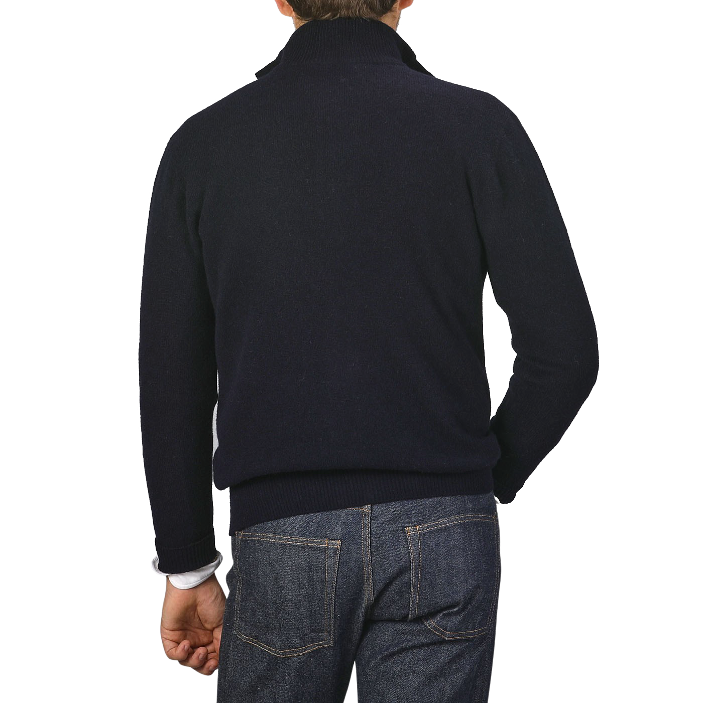 The image shows the back view of a person wearing a dark turtleneck sweater and blue jeans against a plain background, subtly hinting at the quality craftsmanship of an Altea Navy Blue Shetland Wool Button Cardigan.