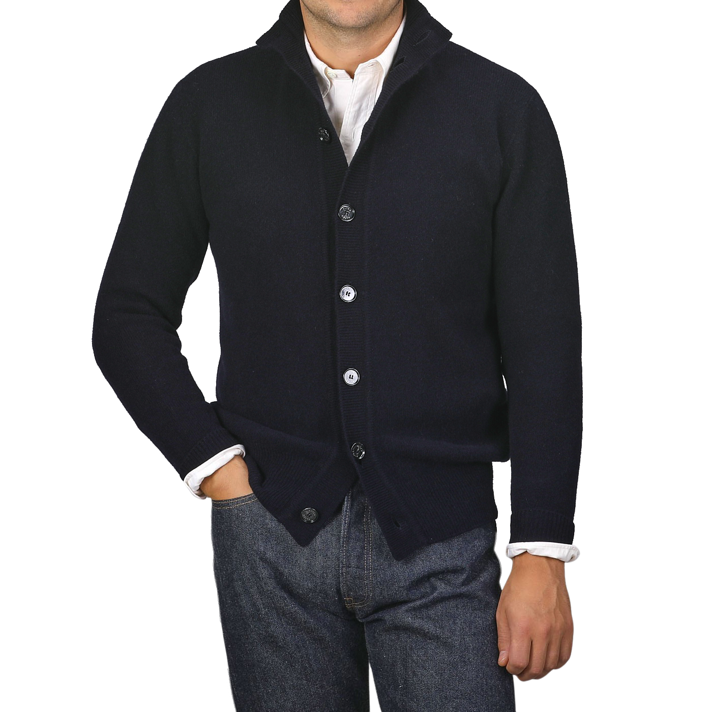 A person wearing an Altea Navy Blue Shetland Wool Button Cardigan over a white shirt, with one hand in their pocket, stands against a plain gray background.