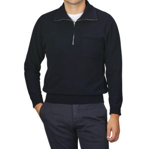 A person wearing a Navy Blue Wool Fleece 1/4 Zip Sweater by Altea, with a small chest pocket, paired with dark pants. The face is not visible.