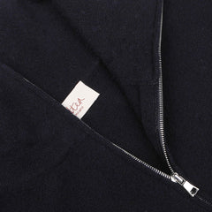 Close-up of a navy blue wool fleece 1/4 zip sweater with a silver zipper, showcasing a partially exposed label with the text "Altea" and "Made in Italy" underneath.