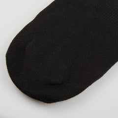 A close up of a Amanda Christensen Black Cotton Invisible Sock on a white surface.