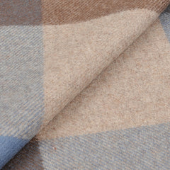 A close-up view of the folded Brown Blue Checked Merino Wool Scarf by Amanda Christensen, showcasing its luxurious pattern in brown, blue, and beige.