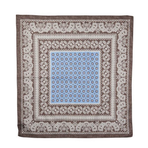 Decorative square bandana with blue center and intricate Brown Melange paisley pattern on a plain background by Amanda Christensen.