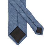An Amanda Christensen Denim Blue Melange Linen Lined Tie on a white background.