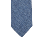 An Amanda Christensen Denim Blue Melange Linen Lined Tie in a denim blue shade on a white background.