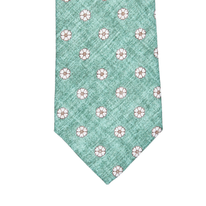 A Green Medallion Print Linen Lined Tie with white flowers on it by Amanda Christensen.