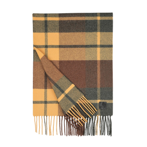 A rectangular scarf by Amanda Christensen, featuring a green and yellow checked pattern with fringed edges and crafted from merino wool.